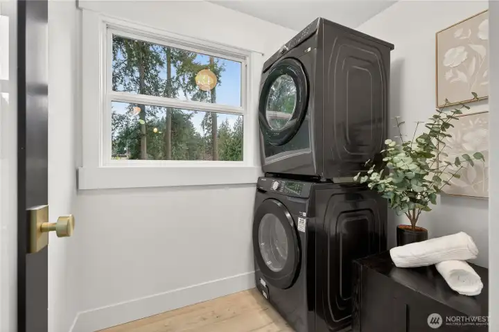 Dedicated laundry room with included washer and dryer provides convenient single-level living functionality separate from main living areas in this thoughtfully designed floor plan.