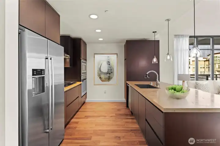 Chef's kitchen flowing seamlessly into an open-concept living area designed for both comfort and entertaining.