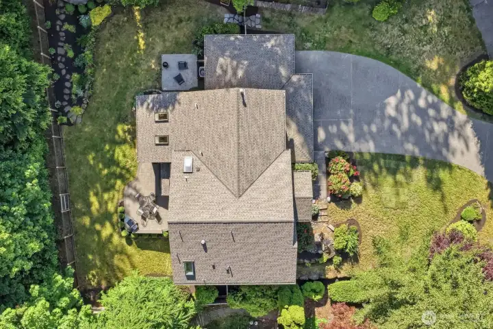 Fully fenced backyard backing to a peaceful greenbelt, offering privacy and beautiful Pacific Northwest scenery