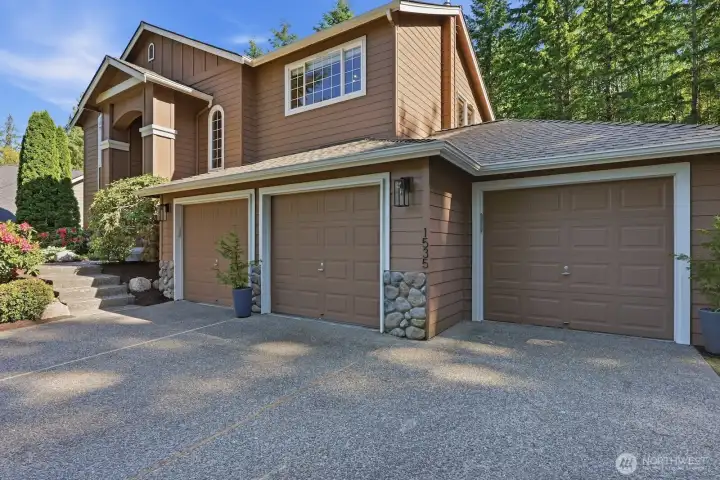 Extended 3-car garage with workshop area and abundant storage.