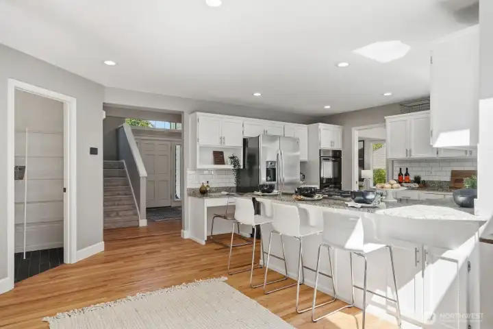 Spacious kitchen bar creates the perfect gathering space between the kitchen and family room.