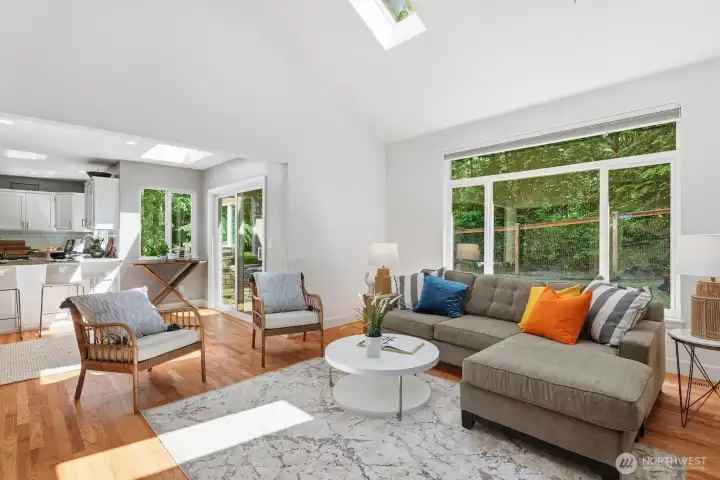 Open-concept design seamlessly connects the kitchen, breakfast bar, and spacious family room with direct access to the backyard patio.