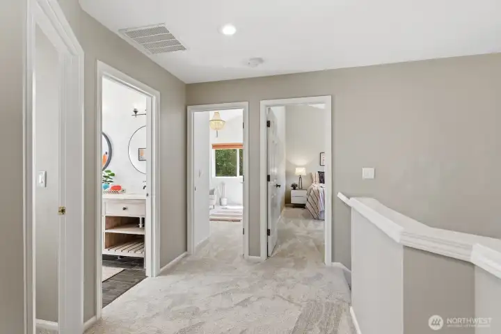 Three additional bedrooms and an updated guest bath are thoughtfully situated on the opposite side of the upper hallway.