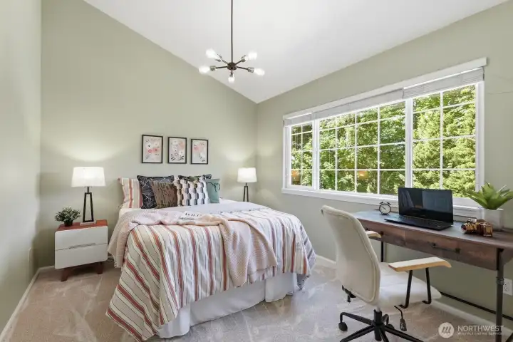 Bedroom 2 features vaulted ceilings, fresh designer paint, new carpet, modern lighting, and a large window with views.