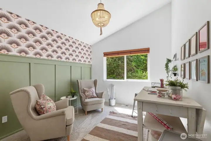 Charming guest bedroom with custom wainscoting accent wall, designer wallpaper, and vaulted ceiling.