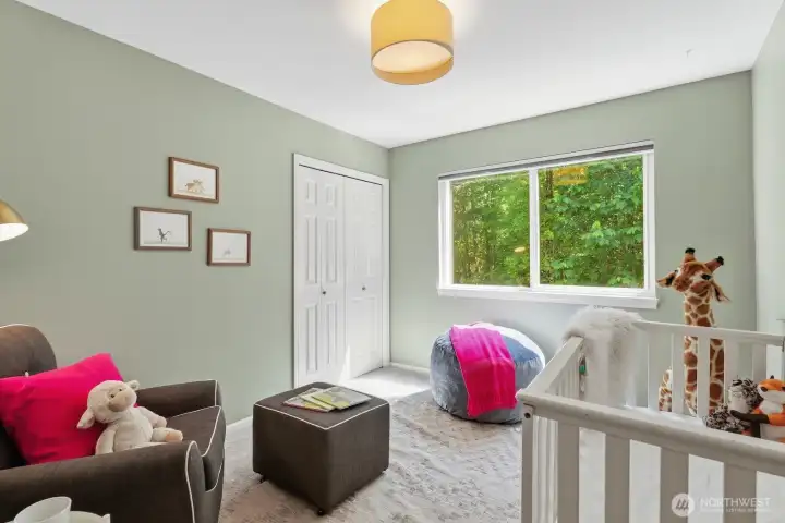 Bedroom 4 offers fresh paint, new carpet, and peaceful greenbelt views.