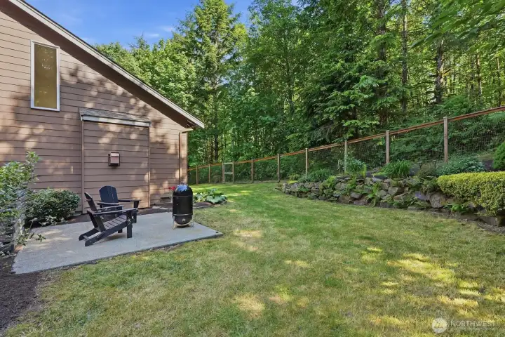 A second patio area or hot tub pad tucked within the backyard provides additional space to unwind and enjoy the peaceful surroundings.