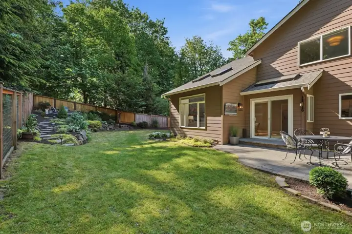 Follow the landscaped stone pathway to a private upper custom built fire pit area with bench seating, landscape lighting and Mt. Si Views.