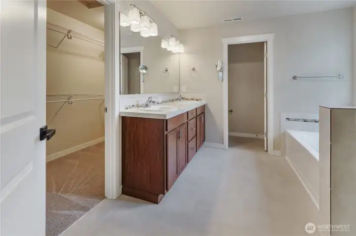 Primary bath. There is also a tiled shower with glass doors.