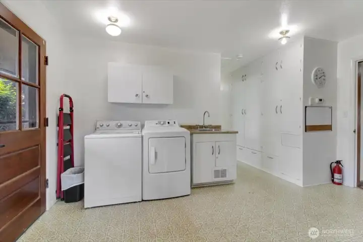 Mudroom/laundry room leading out to the back yard. This room is incredibly large. You could potentially reclaim some of this space to enlarge the 1/2 bathroom (buyer to verify). Mudroom/laundry room leading out to the back yard. This room is incredibly large. You could potentially reclaim some of this space to enlarge the 1/2 bathroom (buyer to verify).