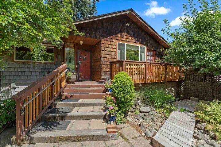 Entry to the Home. Cedar Shake Siding, Newer Deck Railing.