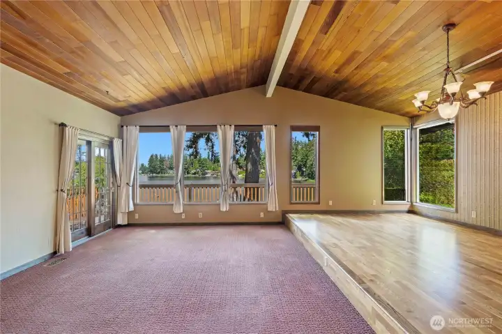 Stunning Living & Dining Rooms w/Wood Planked Ceilings and Real Hardwood Flooring w/Views out to Long Lake. Anderson Sliding Glass Door leads to Viewing Deck.
