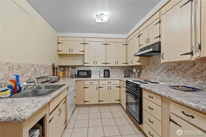 Full Kitchen w/Tile Floors, Laminate Counter, S/S Sink, Dishwasher, Range/Oven w/Hood, S/S Fridge (to the R, not shown)