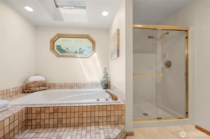 Primary Suite bathroom upstairs with large soaking tub, separate shower and double vanity.
