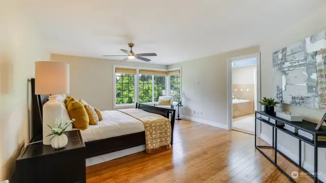 Enter through the French doors to the primary suite.  Spacious and light with views into your private backyard.  A new ceiling fan helps to keep the cool air conditioning moving around.