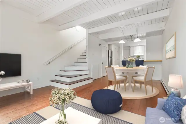 Tall ceilings with white wood plank details give it that beachy vibe. Nice open living room space. Virtually staged.