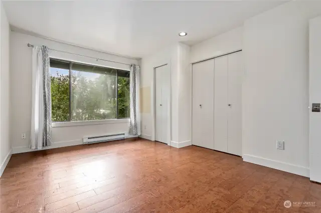 Two closets and a large picture window in the primary bedroom.