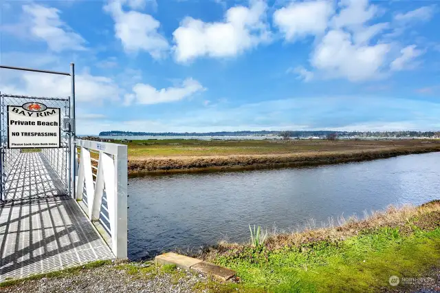 Secure gate on the bridge over the creek leads to the condo's private beach.