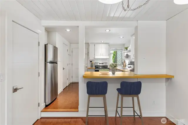 Eat at the breakfast bar or there's room for a dining table. Virtually staged.