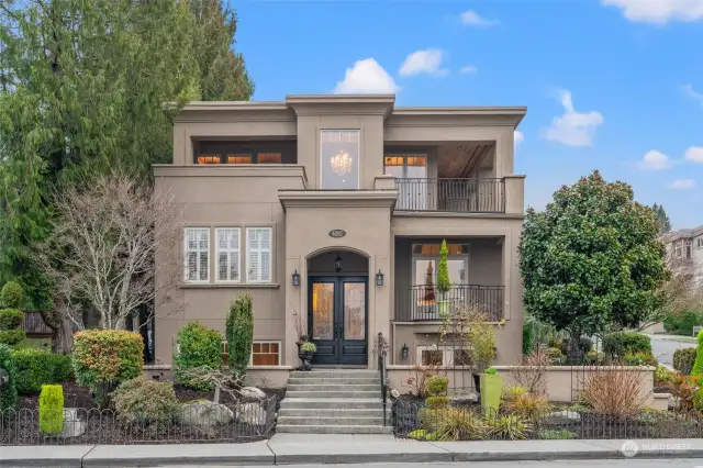 Lush landscaping and French doors provide beautiful curb appeal.