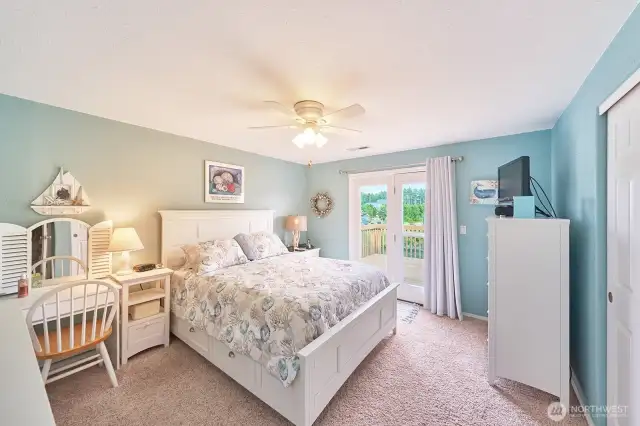 Upstairs bedroom #1 with French doors to the upper deck looking over the canal.