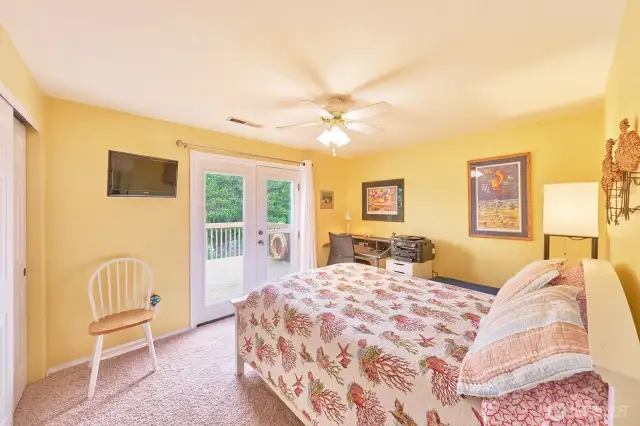 Upstairs bedroom #2 with French doors to the upper deck looking over the canal.