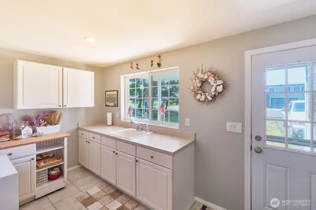 Enter into a large mudroom, perfect for shucking wet boots and coats after a walk on the beach.