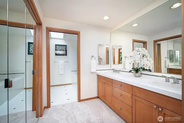 Primary Bath with separate dual vanity area, shower and soaking tub through door. Spacious walk-in closet.