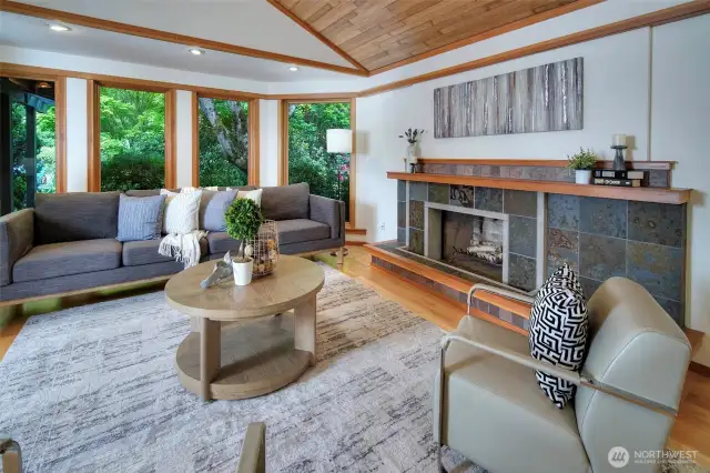 Living Room with fir windows, cedar ceiling, slate fireplace.