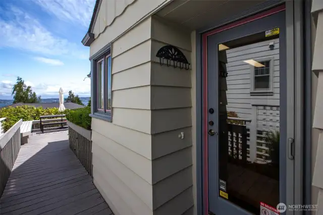 Exterior view of the kitchen door, with the front deck beyond.