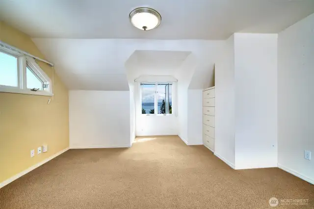 The primary bedroom, on the upper level, faces east towards the Lake & Mountain views.