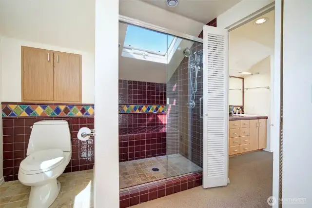 Primary bath, with skylight. To the right there are dual sinks.