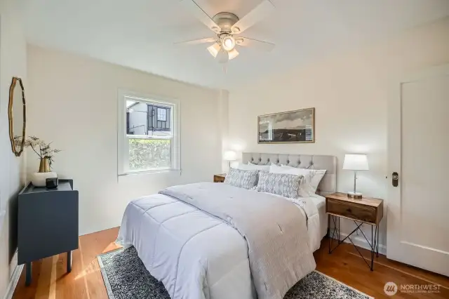 Bedroom one on main floor gets great light and air flow with ceiling fan.