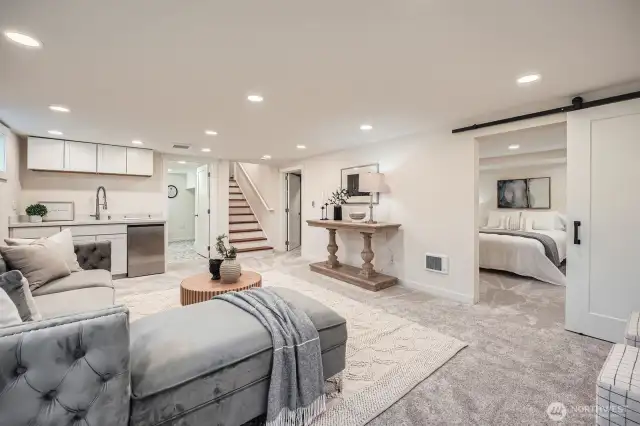 Notice the barn door to the primary bedroom - stylish and sleek!