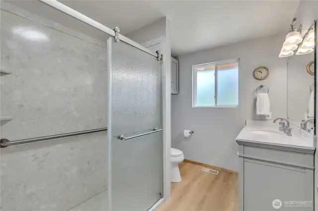 Newly remodeled bathroom with walk-in shower & pretty vanity & storage cabinets ~