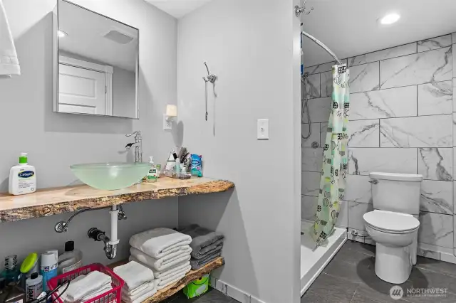 Stylish tile, live edge vanity, vessel sink, large shower w shaving bench and so much more.