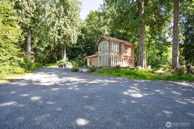 Mature Cedars surround the cozy and efficient main house just feet from the babbling brook.