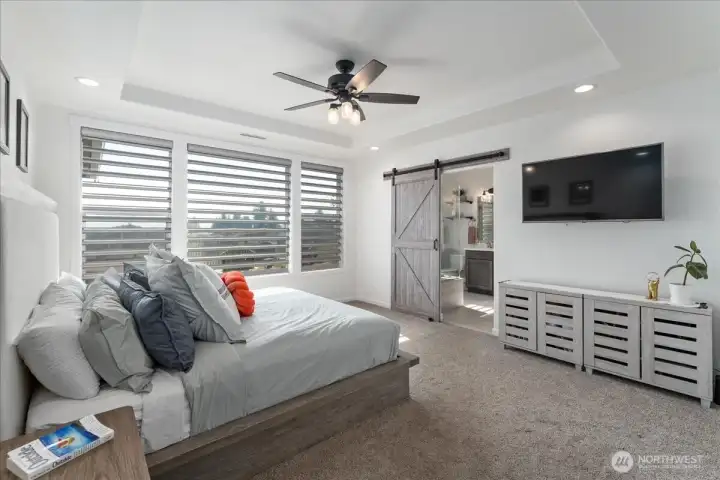 View of Primary Bedroom Suite with barn door leading to the bathroom suite.