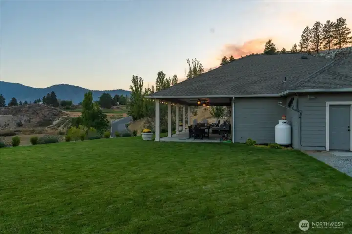 Exterior view of grassy yard and outdoor living area.