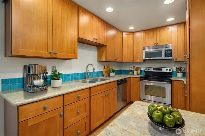 Virtually staged kitchen. Lots of counter space, storage and even a bar to put stools under for dining.