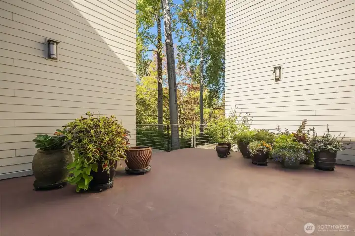 Communal patio area with planters. Lawn cushions are put away for the season but this is a place where neighbors gather.