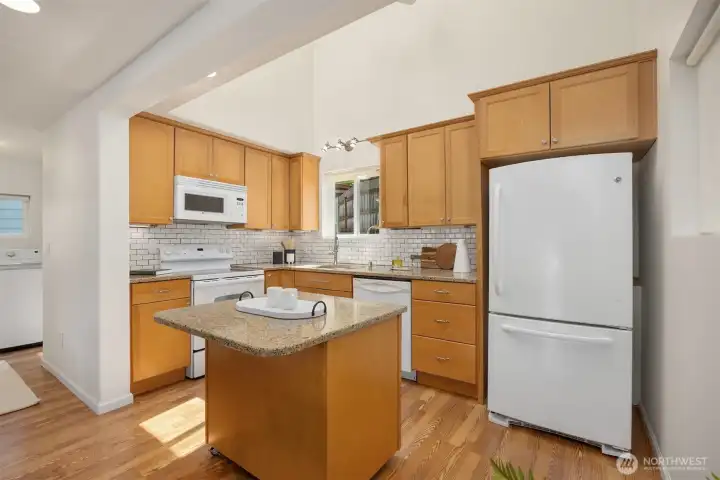 Very nice kitchen with granite counters and wood cabinets. The washer and dryer and full bathroom is to the left.