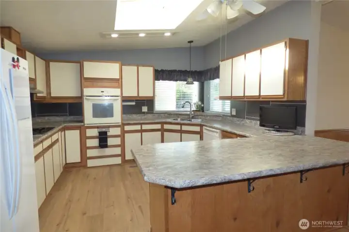 Large kitchen with skylight, fan and lots of counters and storage. TV stays too! Great scenery of what's going on in the park while doing dishes too.
