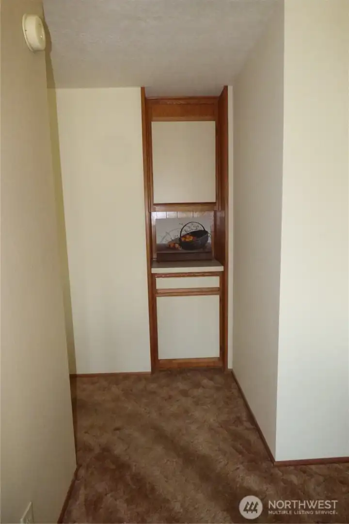 Hall to bedrooms with a little storage area.