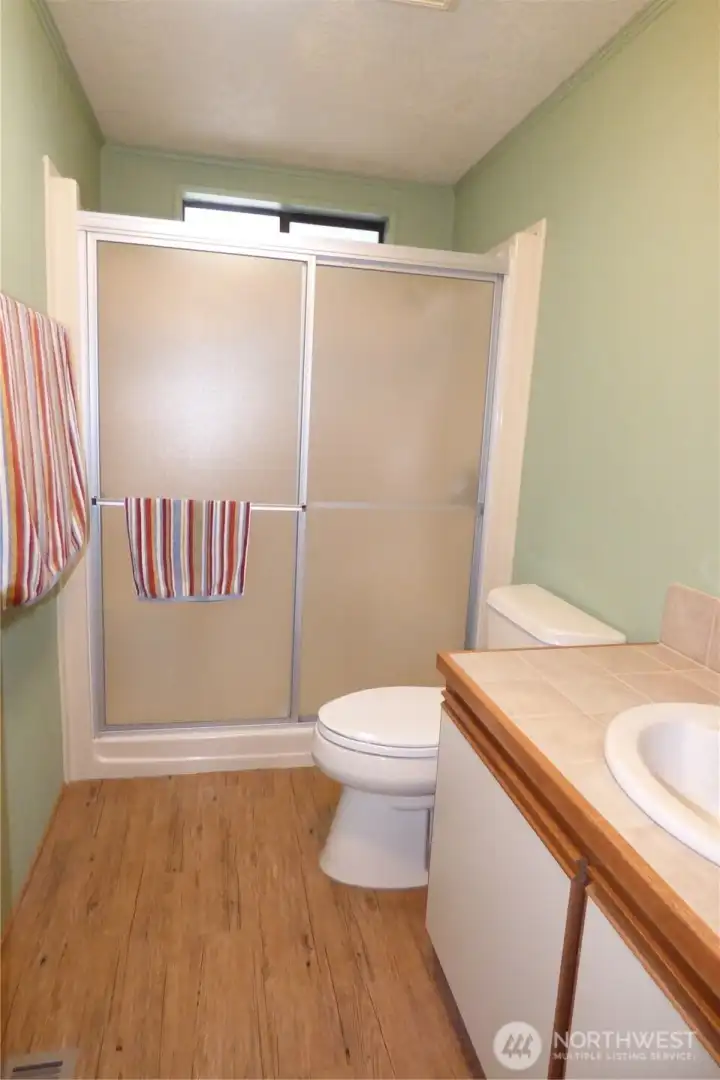 Main 3/4 bathroom with window above shower for ventilation.