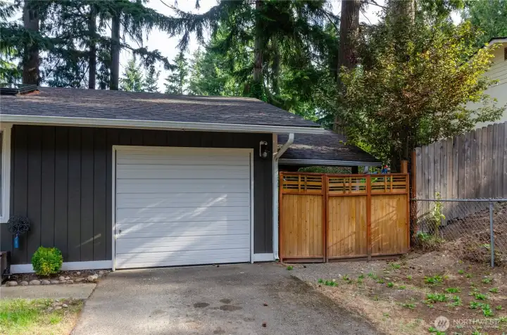 Garage Door and Extra Storage Area. Could be used as additional Covered Parking