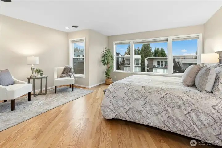 Upstairs you will find the spacious primary suite with beautiful hardwood flooring! Look out these windows to the right and you'll see Lake Washington.