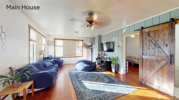 Living room in the main house with original wood flooring