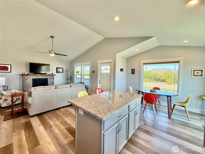 Propame fireplace with custom stone surround and live-edge mantle.