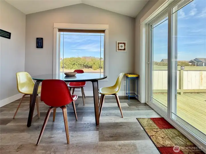 Dining space with door leading to the deck and side yard.